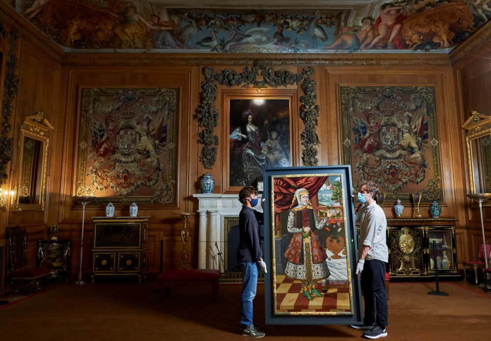 Staff at Windsor Castle move the portraits into place in the King’s Dining Room.